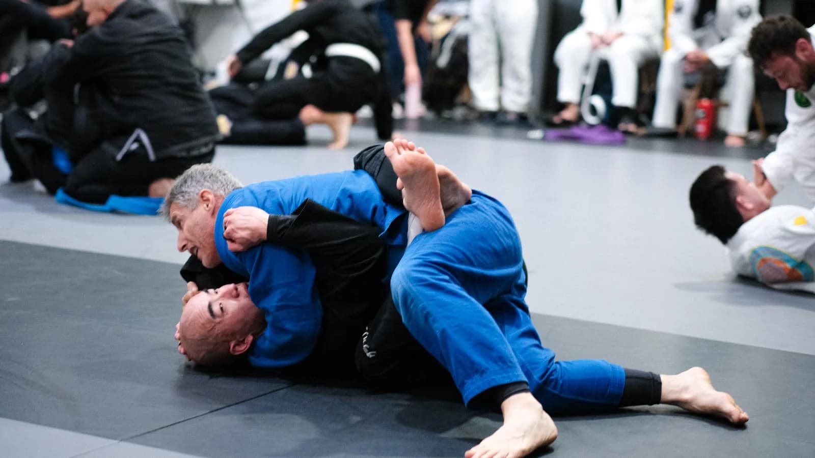 Adult martial arts class with students of various ages training at Nakama BJJ